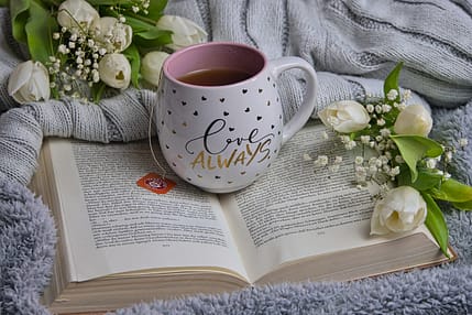Inviting cup of tea resting on an open book